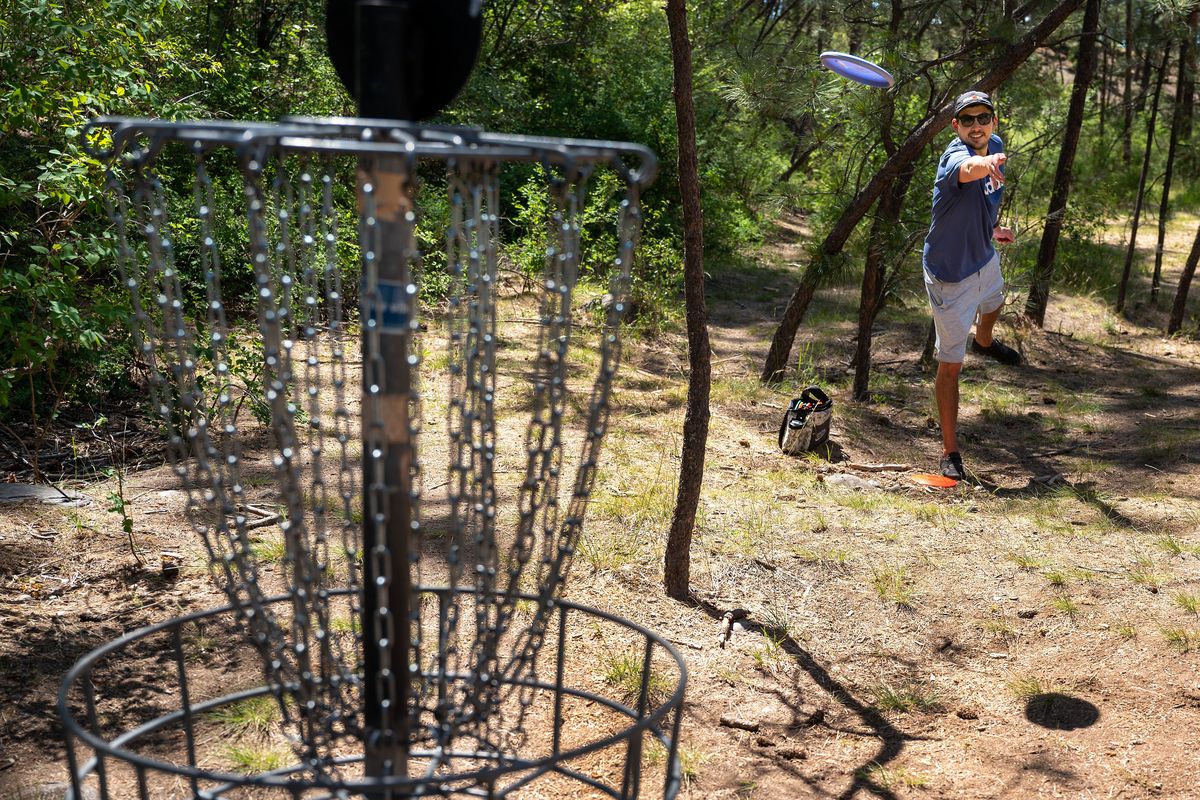 Nick Morris throws his disc at the fifth hole for birdie Tuesday at the city-owned Downriver Disc Golf Course at Riverside State Park. Discover Pass free days will soon be extended to all state recreational sites and lands.  (COLIN MULVANY/THE SPOKESMAN-REVIEW)