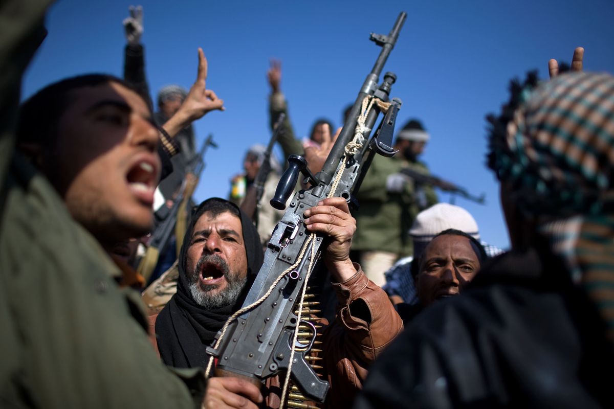 Opposition rebels celebrate victory just west of the city gate of Ajdabiya, Libya, on March 26. (Holly Pickett)