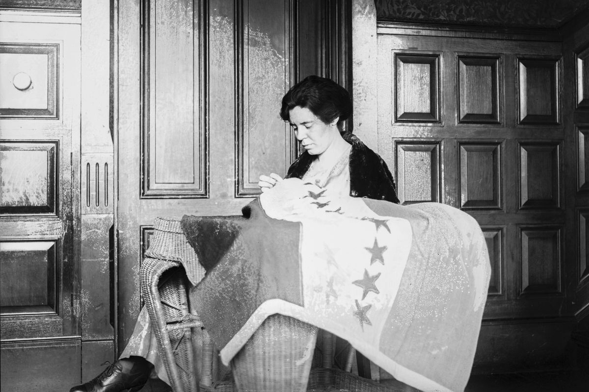 In this 1920s photo, Alice Paul sews a suffrage flag in Washington. One hundred years ago, American women gained the guaranteed right to vote, with ratification of the 19th Amendment. But to suffragist Paul, the vote wasn