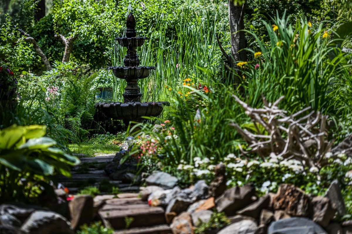 The entrance of the garden created by Vern Harvey, Abdul Samad.and Daniel Dolezal is photographed in Coeur d’Alene on Wed. June 23, 2021. The garden will be part of the Coeur d’lene Garden Club 23rd Annual Garden Tour on Sunday, July 11 2021.  (Kathy Plonka/The Spokesman-Review)