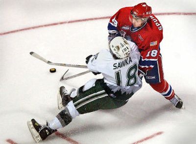 Spokane's Jared Spurgeon, right, muscles Everett's Ryan Sawka away from his angle to the crease at the Spokane Arena in the second period. (Brian Plonka / The Spokesman-Review)