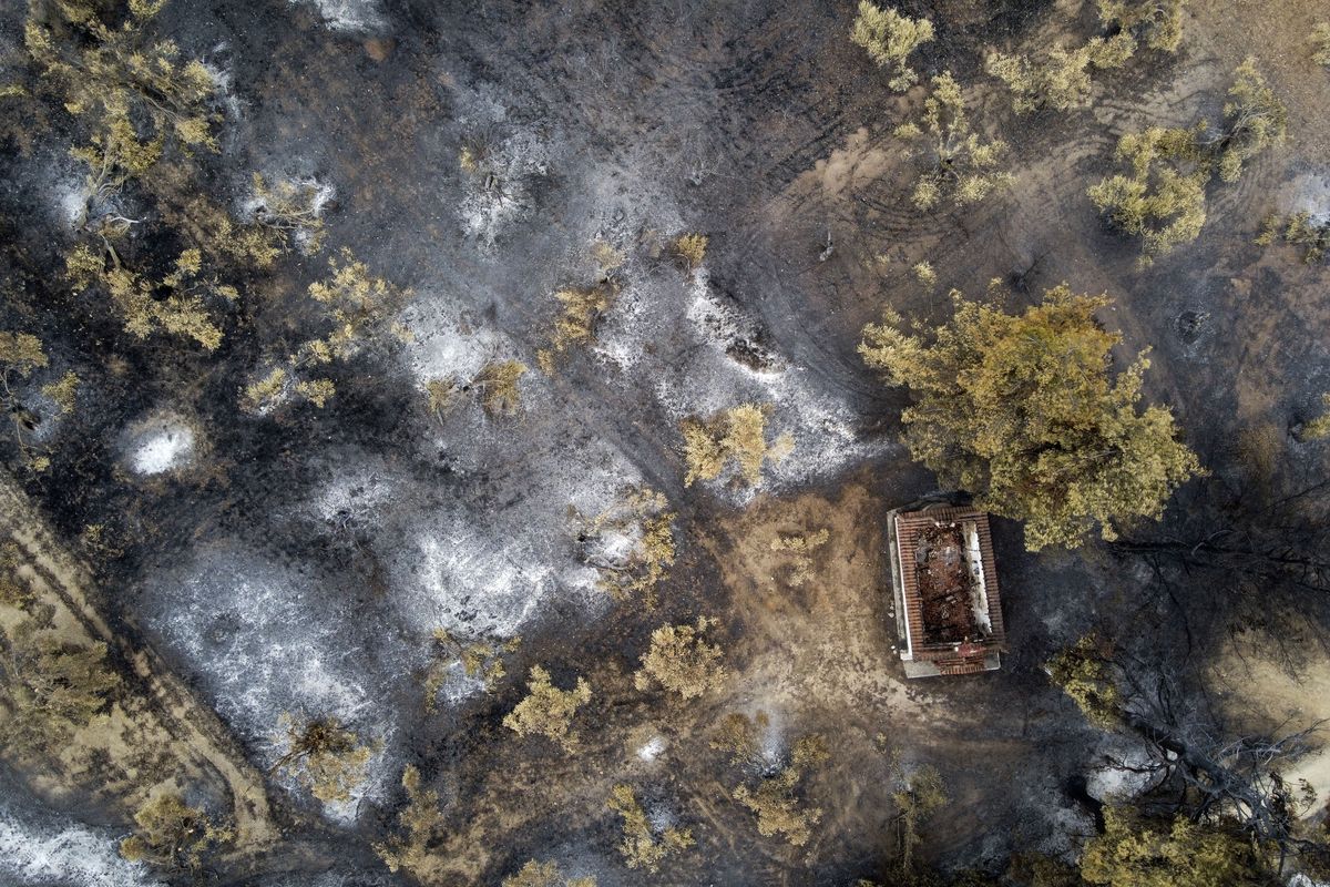 A burnt house at a forest in Agia Anna village on Evia island, about 181 kilometers (113 miles) north of Athens, Greece, Wednesday, Aug. 11, 2021. Hundreds of firefighters from across Europe and the Middle East worked alongside Greek colleagues in rugged terrain Wednesday to contain flareups of the huge wildfires that ravaged Greece
