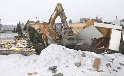 A Rob’s Demolition backhoe finishes what snowstorms started, knocking down what’s left of Hancock Fabrics, 1020 W. Francis Ave., on Wednesday.  (CHRISTOPHER ANDERSON / The Spokesman-Review)