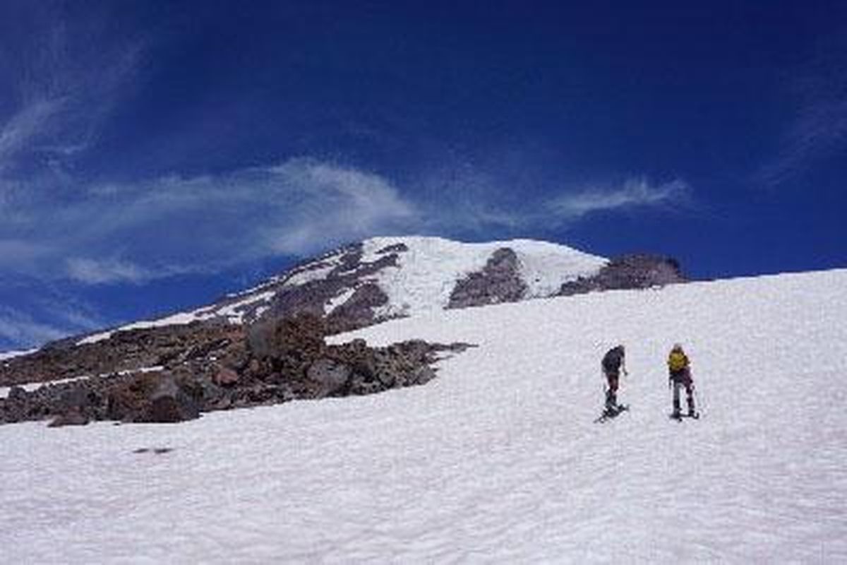 Maks and Owen Page skin up a snowfield for August skiing at Mount Rainier National Park. (TR PAGE PHOTO)