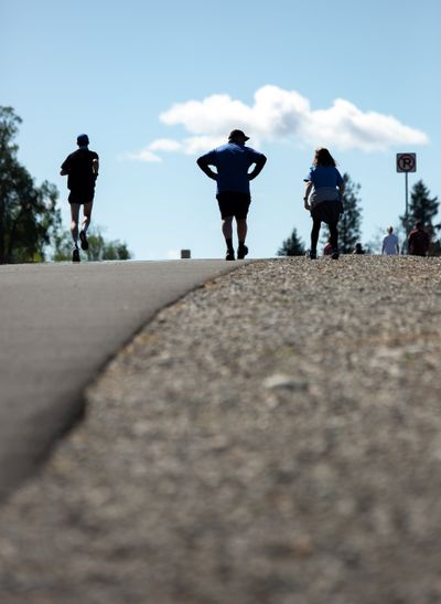 Runners reach the top of “Doomsday Hill” Sunday on Pettet Drive during Virtual Bloomsday in Spokane.  (Libby Kamrowski/ THE SPOKESMAN-R)