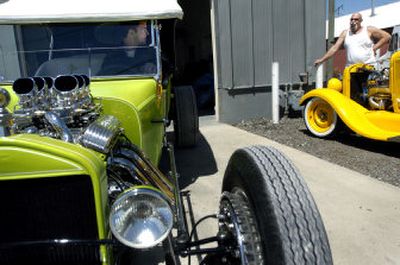 
Gary Babcock admires a 1924 Ford touring hot rod restored by Extreme Customs owner Russ Freund, left, outside the Spokane Valley business on Wednesday.
 (Holly Pickett / The Spokesman-Review)