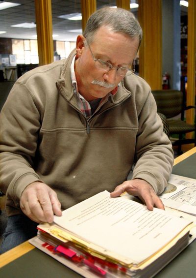 Richard Barber looks through documents on Oct. 15 that he's amassed as he has investigated Remington Arms Co. following the death of his son in 2000 from an accidental gun discharge. Photo by Brett French/Billings Gazette (Photo by Brett French/Billings G / Photo by Brett French/Billings G)