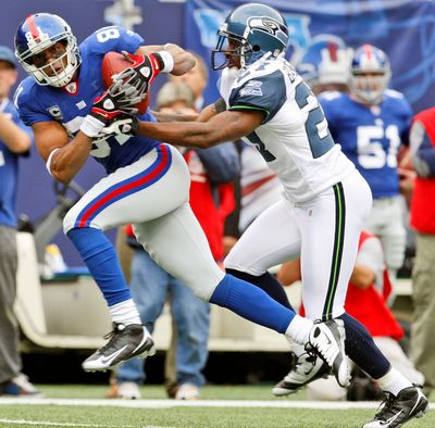 Amani Toomer’s Giants roughed up Jordan Babineaux’s Hawks.  (Associated Press / The Spokesman-Review)