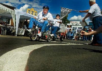 
Jack Stewart leans into a corner and crosses the finish line during the 