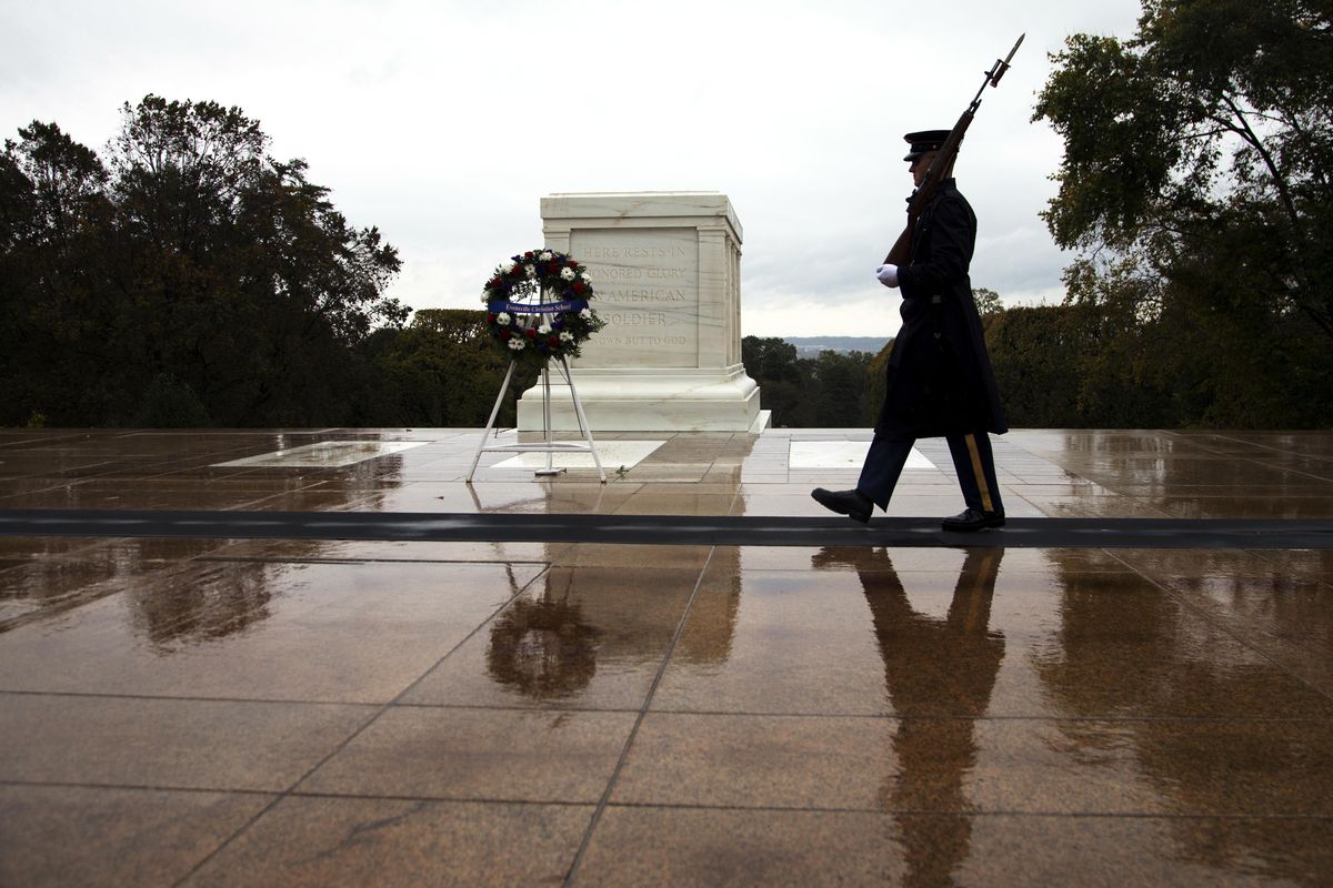 In this Oct. 22, 2014, file photo, a Tomb guard walks at the Tomb of the Unknown Soldier in Arlington National Cemetery in Arlington, Va. The tomb is one of the cemetery