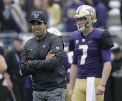 Washington offensive coordinator and quarterbacks coach Bush Hamdan, left, stands on the field during warmups before  the Oct. 20 game against Colorado  in Seattle. (Ted S. Warren / AP)