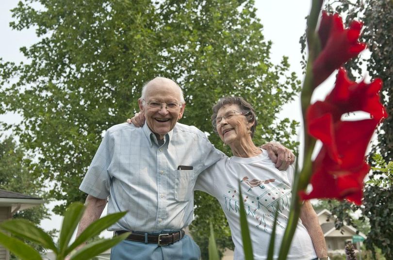 John and Amy Roberson stand near their wedding flower, the red gladiolus, in their yard in Greenacres on Wednesday, Aug. 9, 2017. The two are celebrating their 70th wedding anniversary. (Kathy Plonka / The Spokesman-Review)