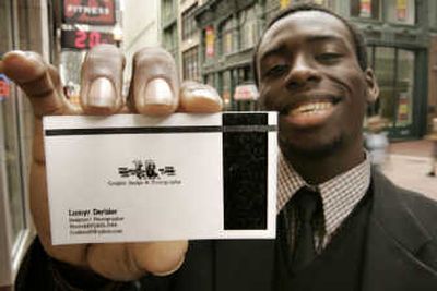 
Lumyr Derisier of Milton, Mass., displays a business card he designed. Staples Inc. earlier this month unveiled a new business line that allows customers to design and print their own business cards in as little as 30 minutes. Associated Press photos
 (Associated Press photos / The Spokesman-Review)