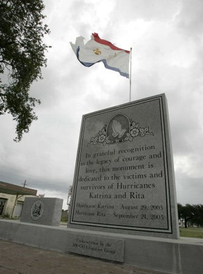 
The  city flag flies over a Hurricane Katrina memorial Wednesday in New Orleans. In the city rebuilding plan is a proposal for a much larger memorial to hurricane victims and survivors.
 (Associated Press / The Spokesman-Review)