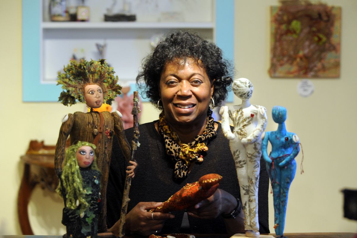  Artist Denise Roberson likes to think of her creations as soft sculptures of feminine characters. She is seen with some of her work at the Manic Moon Gallery, 1625 N. Monroe St., in Spokane. (Jesse Tinsley)