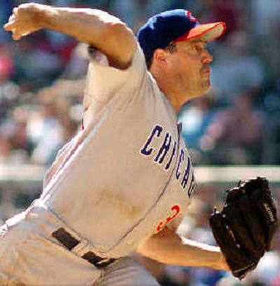 Los Angeles Dodgers pitcher Greg Maddux, left, celebrates with