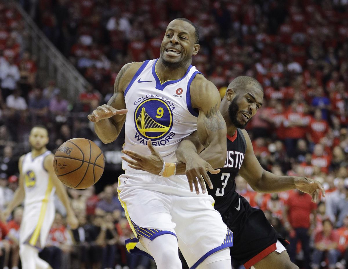 Golden State Warriors forward Andre Iguodala (9) is fouled by Houston Rockets guard Chris Paul (3) during the second half of Game 1 of the NBA basketball Western Conference Finals, Monday, May 14, 2018, in Houston. (David J.Phillip / Associated Press)
