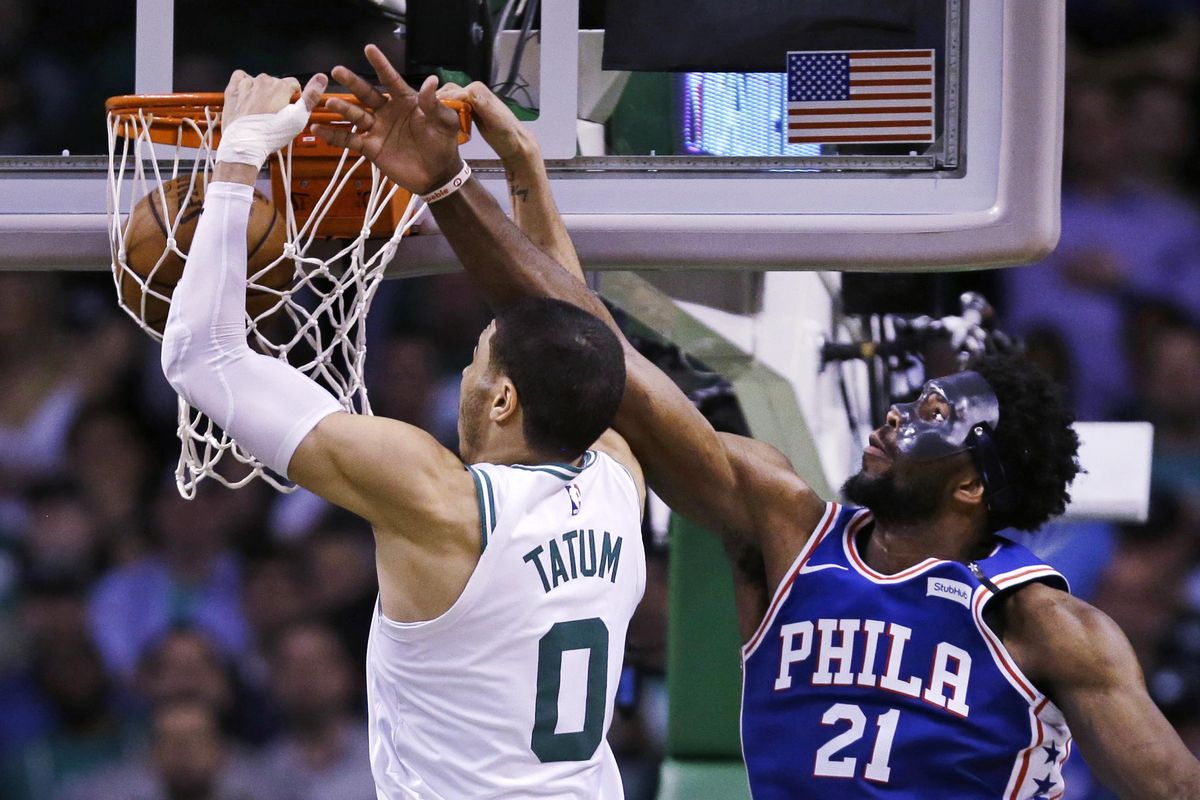 Boston Celtics forward Jayson Tatum (0) dunks after a drive past Philadelphia 76ers center Joel Embiid (21) during the second half of Game 5 of an NBA basketball playoff series in Boston, Wednesday, May 9, 2018. Tatum scored 25 points as the Celtics defeated the 76ers 114-112. (Charles Krupa / Associated Press)
