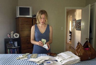 
Every two weeks on payday, Cassie Breithaupt will retreat to her bedroom and divide a set amount of cash into eight envelopes for groceries, gas, haircuts, babysitting, clothes and shoes, restaurants, entertainment and recreation, and 
