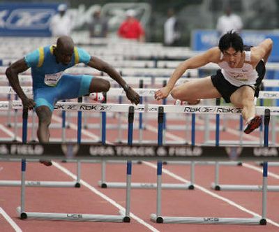 
Allen Johnson, left, and China's Xiang Liu run neck and neck in the 110-meter hurdles at the Reebok Grand Prix in New York. 
 (Associated Press / The Spokesman-Review)