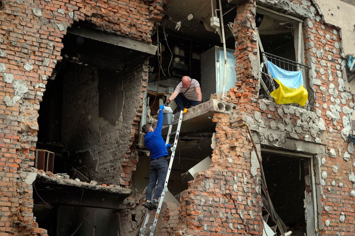 Residents take out their belongings from their house ruined by the Russian shelling in Irpin close to Kyiv, Ukraine, on Saturday.  (Efrem Lukatsky)