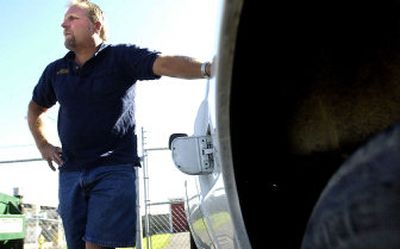 
Jeff Keen of Motion Auto Supply stands next to one of several delivery trucks Thursday in the Spokane Valley that have had gas stolen by means of cut fuel lines underneath the vehicles. 
 (Brian Plonka / The Spokesman-Review)