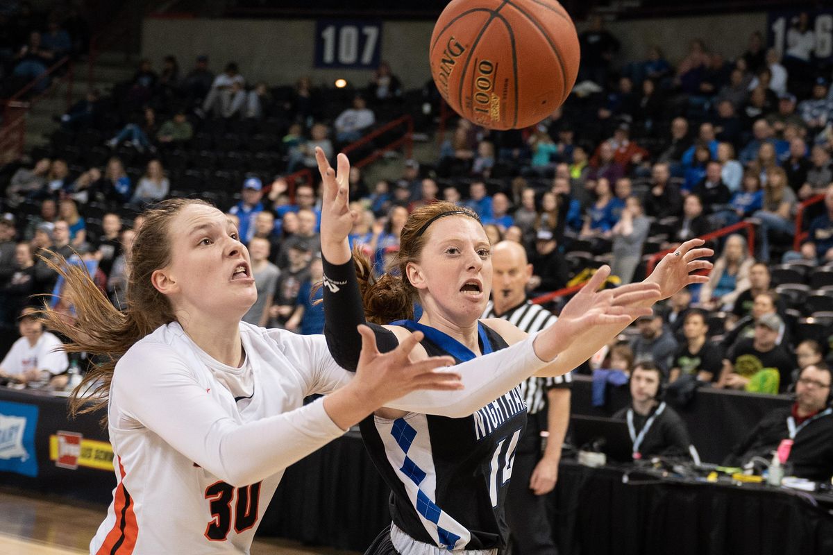 Pomeroy post Maddy Dixon (30)  and Oakesdale guard Julie Baljo (14) chase a loose ball out of bounds during a WIAA State 1b semi-final Hardwood Classic basketball game, Friday, March 6, 2020, in the Spokane Arena. (Colin Mulvany / The Spokesman-Review)