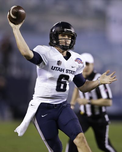 Utah State’s Darell Garretson fires a pass on the run against Northern Illinois. (Associated Press)