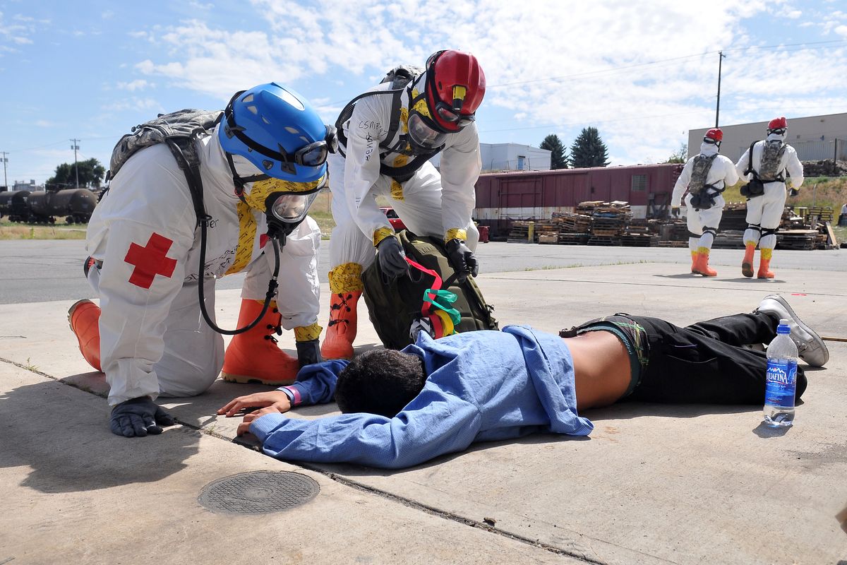 At a fire training facility east of Spokane Community College, a two-person National Guard triage team assesses a victim, played by Kawika Vargas, during a drill Wednesday. The new Homeland Response Force will respond to disasters.. (PHOTOS BY JESSE TINSLEY)