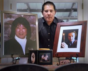 Travis Melcher stands with portraits of his mother, Bev Saruwatari, and his brother Jerud Melcher on June 17, 2010, at his home. (Christopher Anderson / The Spokesman-Review)