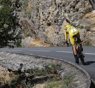 Britain's Chris Froome, wearing the overall leader's yellow jersey, speeds downhill Friday during the thirteenth stage of the Tour de France cycling race. The individual time trial over 37.5 kilometers (23 miles) started in Bourg-Saint-Andeol and finished in La Caverne du Pont-d'Arc, France. (Christophe Ena / Associated Press)