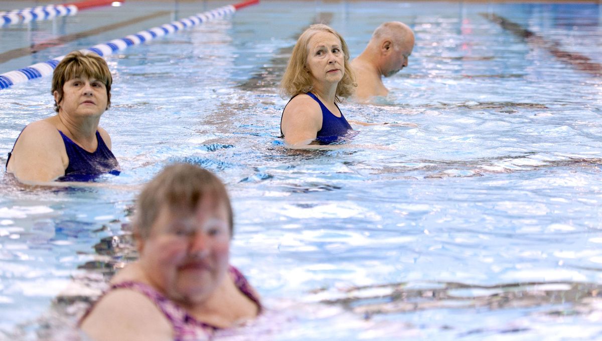 MS patient Shauna Miller, center watches for instruction during the Auqua MED/ MS class at The Kroc Center in Coeur d