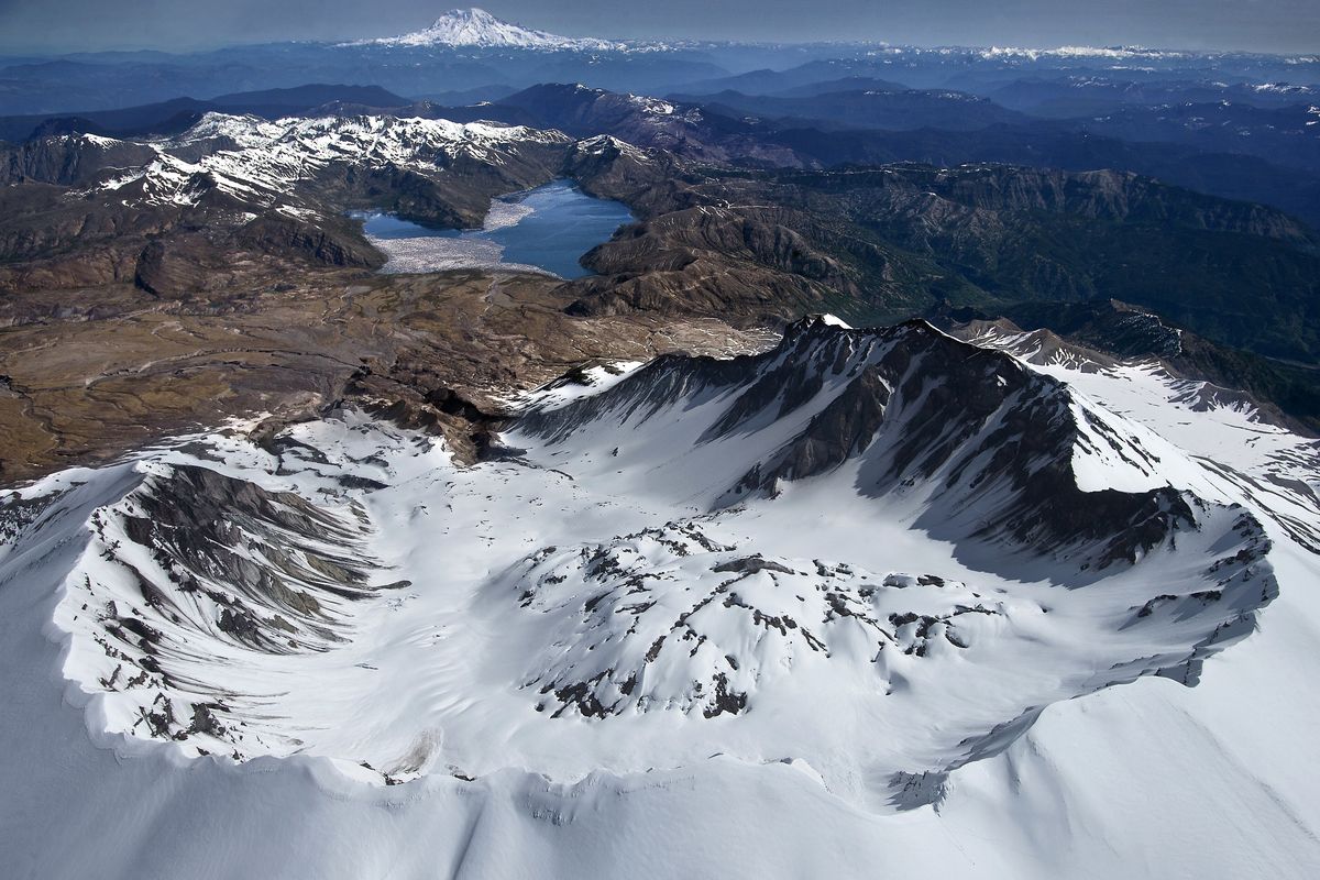 The panoramic view of the south rim of Mount St. Helens, looking past a still venting lava dome north toward Spirit Lake and Mount Rainier, is awe-inspiring, but scientists are focused on a repressurizing of the magma chamber below the mountain.