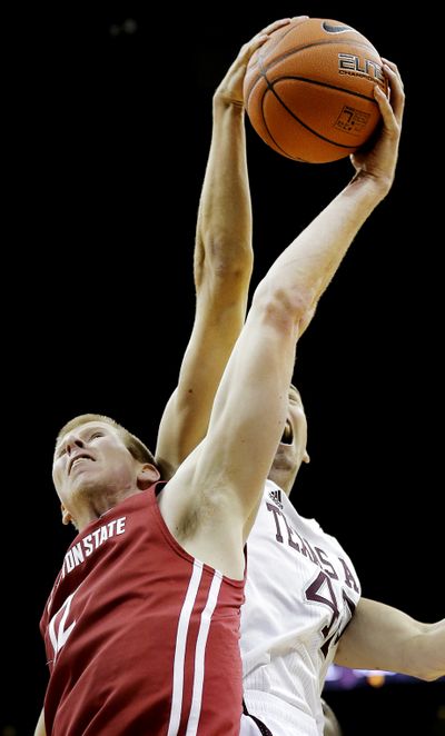 Washington State forward Brock Motum, left, and Texas A&M forward Jarod Jahns battle for a rebound during the first half of an NCAA gameTuesday in Kansas City. (Associated Press)