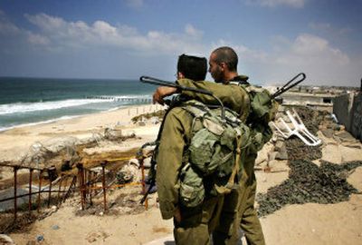 
Israeli soldiers look out at the sea at a dismantled former Israeli navy base on the coast near the former Jewish settlement of Rafiah Yam in the southern Gaza Strip. Israeli troops demolished the last military installations in the Gaza Strip on Friday in final preparations to complete the pullout by Tuesday after 38 years of occupation. 
 (Associated Press / The Spokesman-Review)