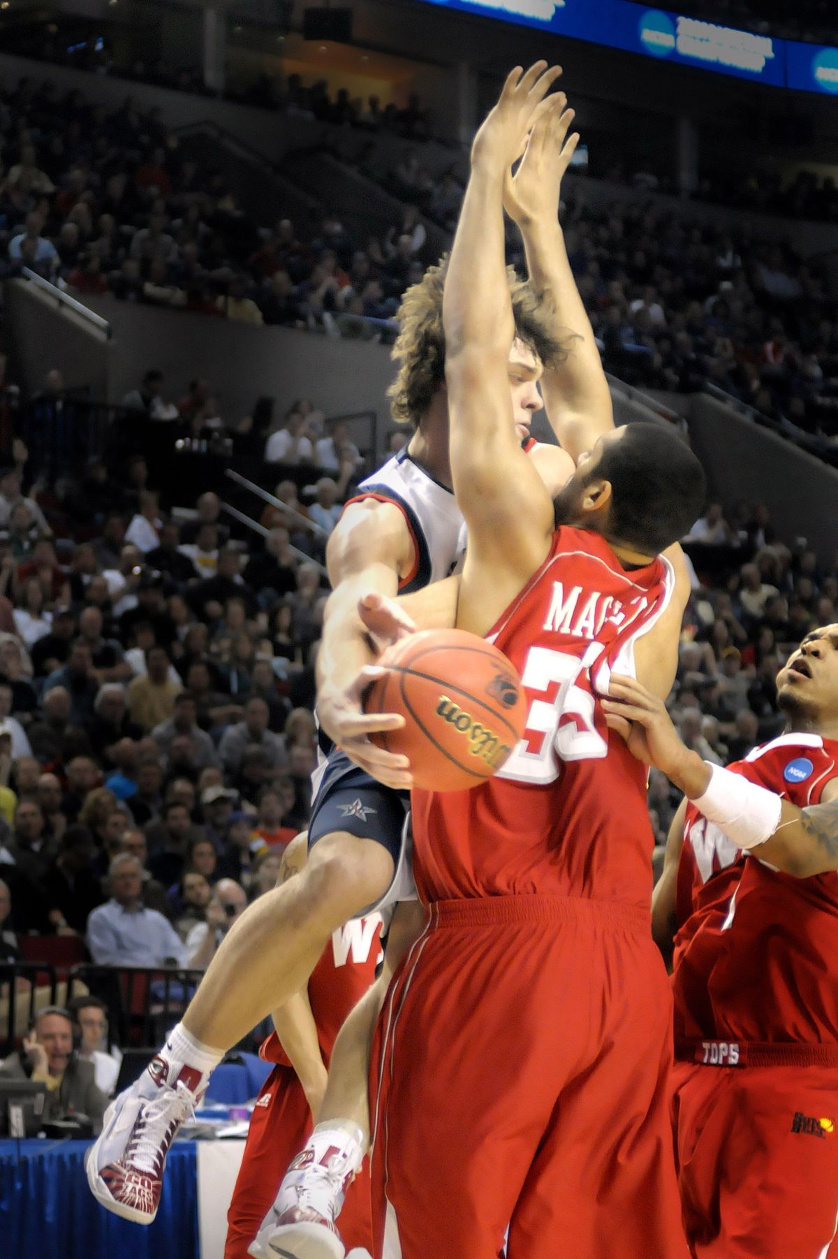 Matt Bouldin wraps a pass around D. J, Magley of Western Kentucky as he flies to the basket. (Christopher Anderson / The Spokesman-Review)