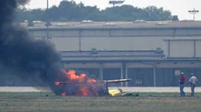 
A biplane burns after slamming into the runway during a performance at the Dayton Air Show on Saturday. Jim LeRoy, an award-winning stunt pilot,  was killed. Associated Press
 (Associated Press / The Spokesman-Review)
