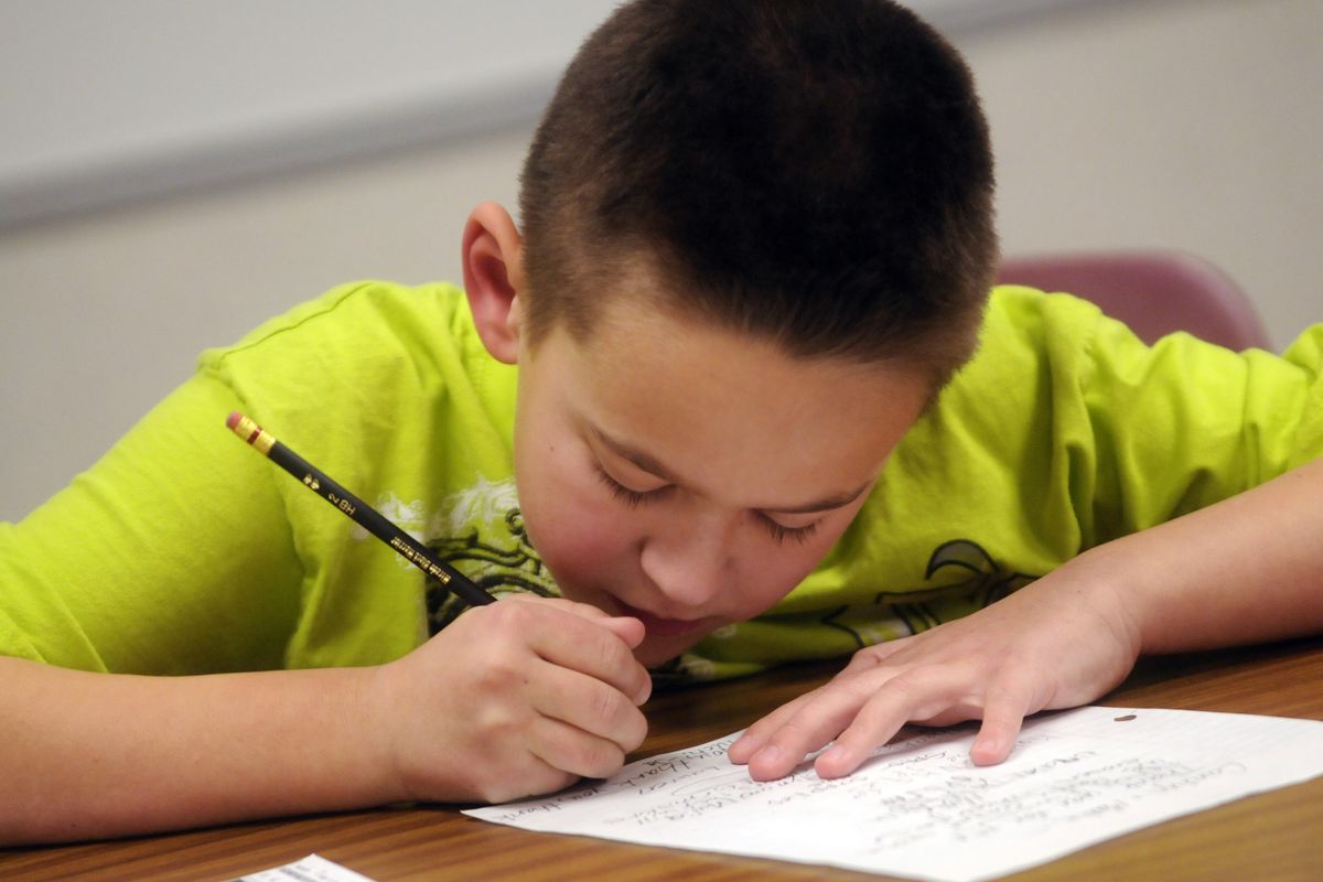 Broadway Elementary fourth-grader Jackson Burchett works on his homework at Homework Helpers.