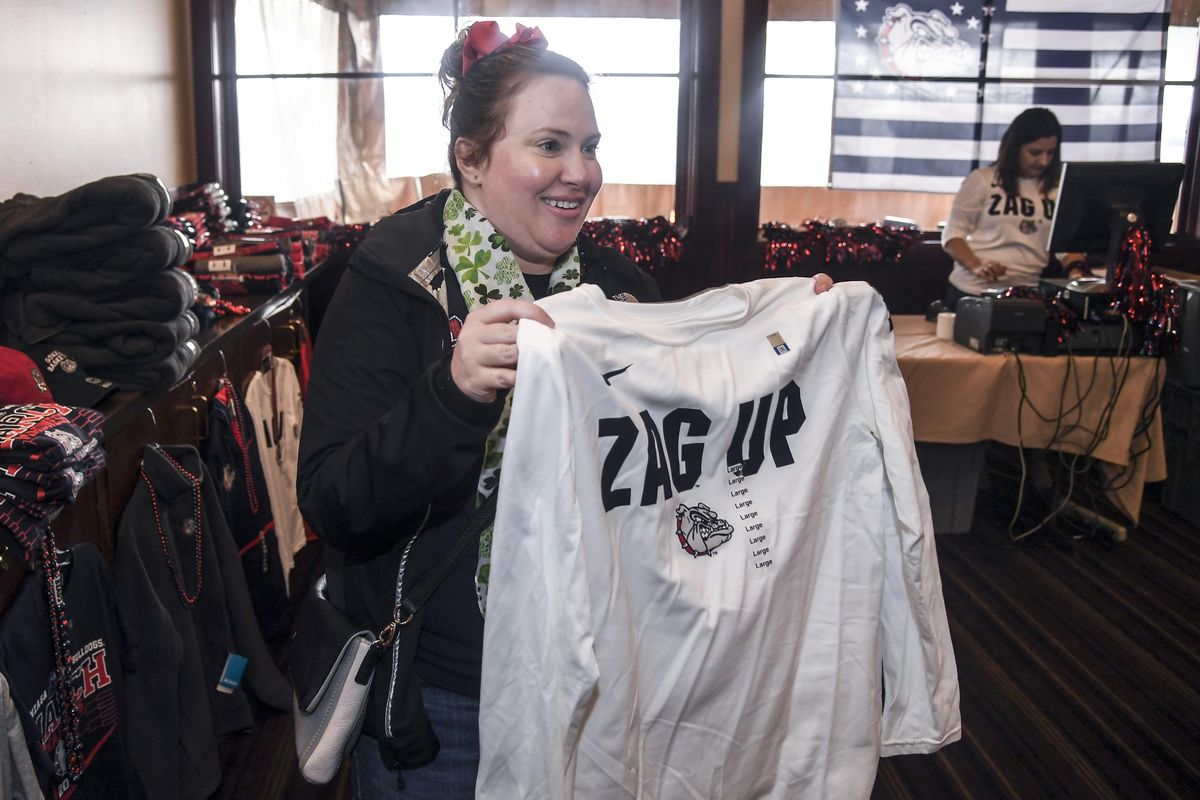 Gonzaga fan Julia DiGrazia checks out Zags gear at a gathering at the Stone House before GU played Ohio State last Saturday in Boise. (Dan Pelle / The Spokesman-Review)