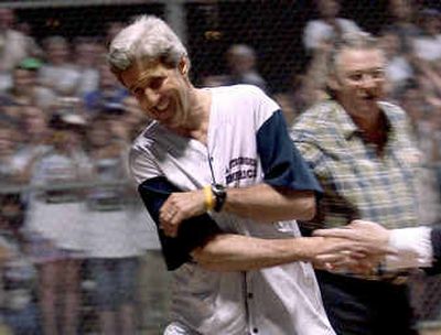 
Democratic presidential candidate Sen. John Kerry, D-Mass. is congratulated after scoring a run in a game of softball at Heritage Park in Taylor, Mich., on Sunday. 
 (Associated Press / The Spokesman-Review)