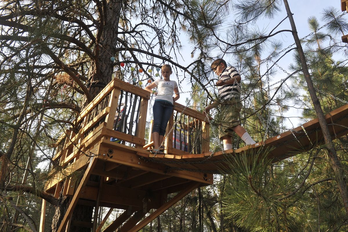 Emma, 12, and Calen Wiechert, 9, stand in their treehouse at their home in Mead.