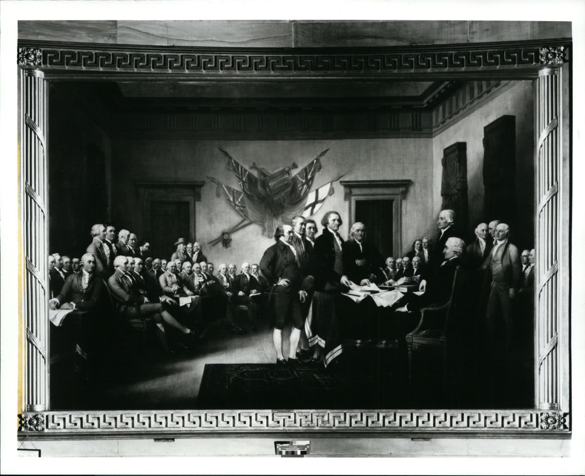 The Declaration of Independence is signed on July 4, 1776. Standing, center (L to R): John Adams (Massachusetts), Roger Sherman (Connecticut), Robert R. Livingston (New York), Thomas Jefferson (Virginia) and Benjamin Franklin (Pennsylvania).  (Spokesman-Review archives)