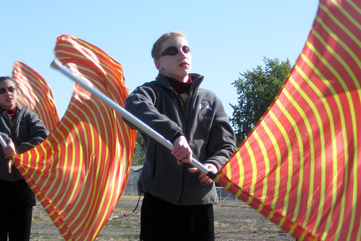 Members of the Mt. Spokane High School color guard warm up before the Pacific Northwest Marching Band Championships Saturday at Joe Albi Stadium. (The Spokesman-Review)