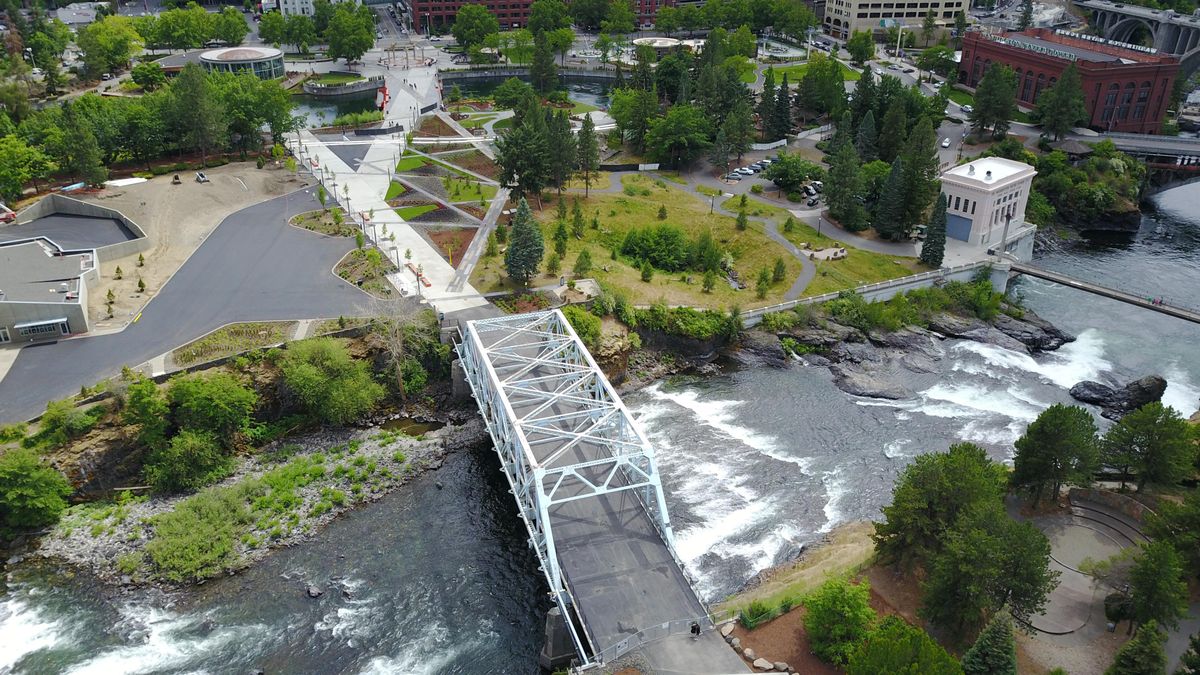 The Central Promenade walkway through Riverfront Park, including the Howard Street Bridge, foreground, is shown Friday, June 21, 2019 in Spokane. The refurbished and landscaped walk is preparing to open. The deteriorating blue bridge, once judged unsafe for use, has been modified to continue serving as a pedestrian bridge. (Jesse Tinsley / The Spokesman-Review)