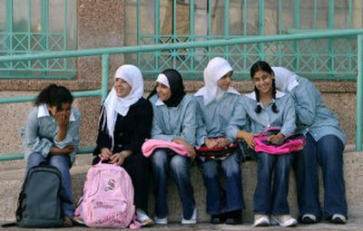 
Palestinian girls sit outside their closed school in the West Bank town of Ramallah on Sunday. 
 (Associated Press / The Spokesman-Review)