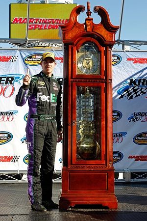 Denny Hamlin celebrates with his Grandfather Clock for winning the NASCAR Camping World Truck Series Kroger 200 at Martinsville Speedway on Saturday. Photo Credit: Geoff Burke/Getty Images for NASCAR (Geoff Burke / Getty Images North America)
