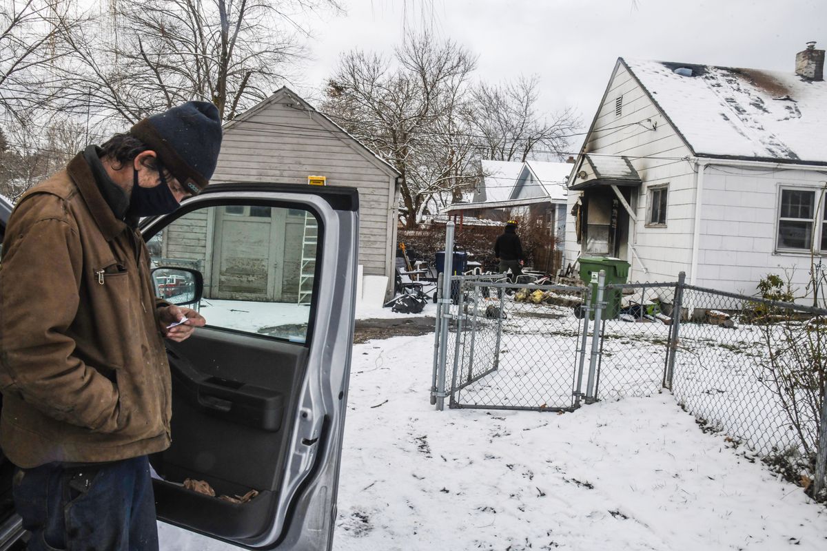 Christopher Majoros waits outside the house he was living in after a fire broke out on Tuesday on the corner of Fifth Avenue and Cook Street in Spokane. His former girlfriend, Caterina Houseman, was burned and his two dogs died in the fire.  (Dan Pelle/The Spokesman-Review)