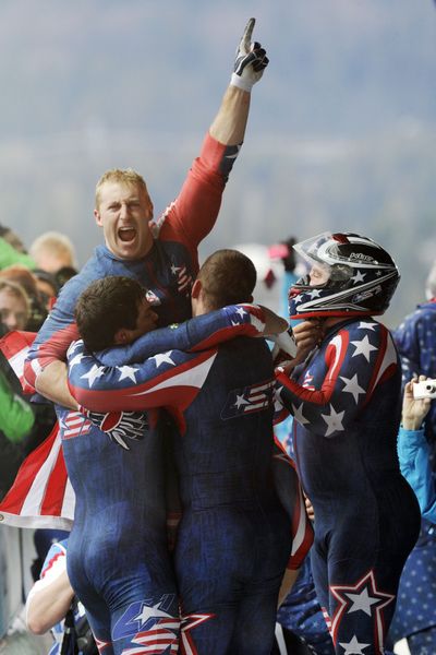 USA-1 teammates celebrate their gold medal finish in four-man bobsled Saturday.  (Associated Press)