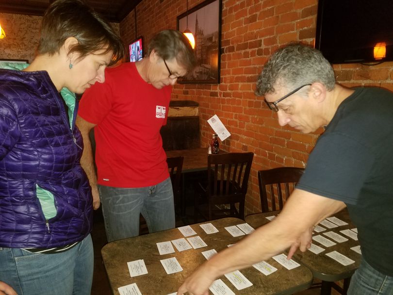 World Tour hosts from the Banff Mountain Film Festival -- Suzanne White and Paul Price -- meet at Post Street Ale House to help Mountain Gear's Phil Bridgers, center, select the lineup of films to show in Spokane on Nov. 17-19 at the Bing Crosby Theater. (Rich Landers)