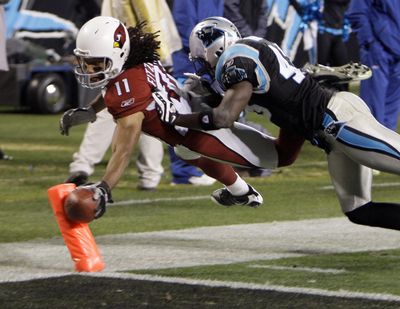 Arizona’s Larry Fitzgerald hits the pylon with the ball for a TD as Carolina’s Chris Harris defends during the second quarter. (Associated Press / The Spokesman-Review)